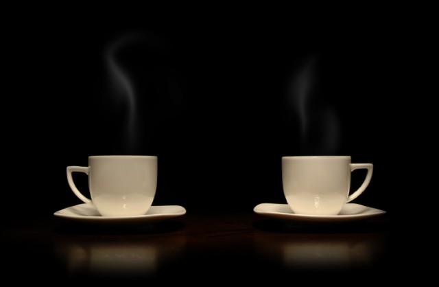 Two coffee cups black background