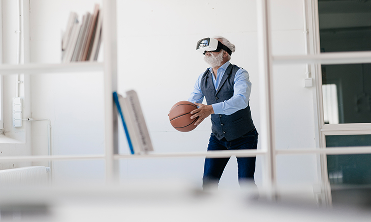 A gentleman with virtual reality goggles and a basketball