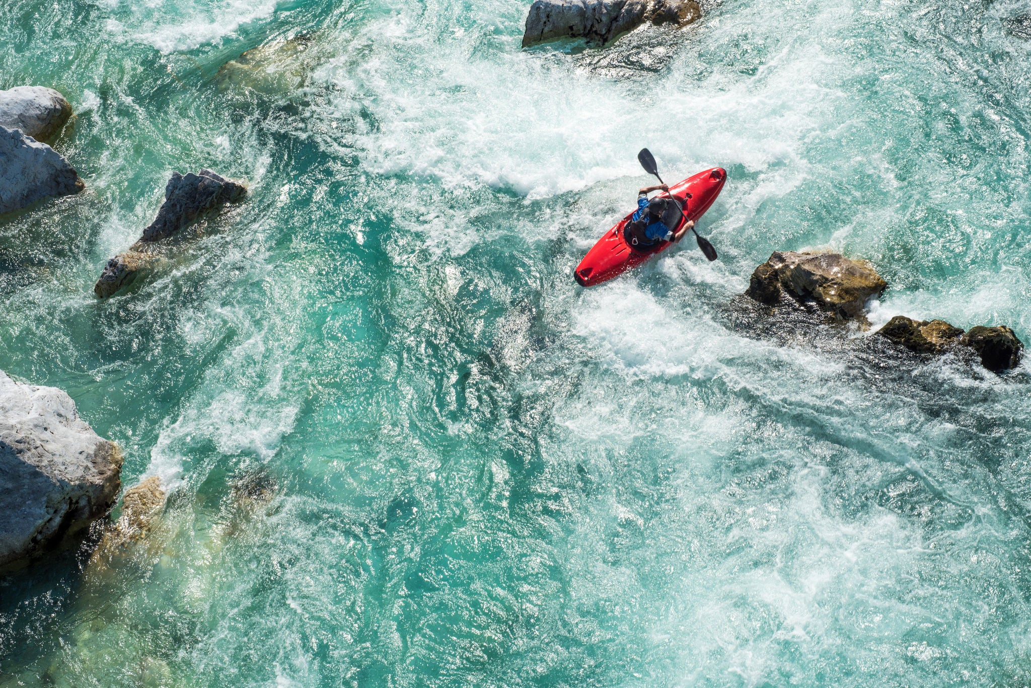 Mature Man Kayaking On  River Soca Rapids - High Angle View