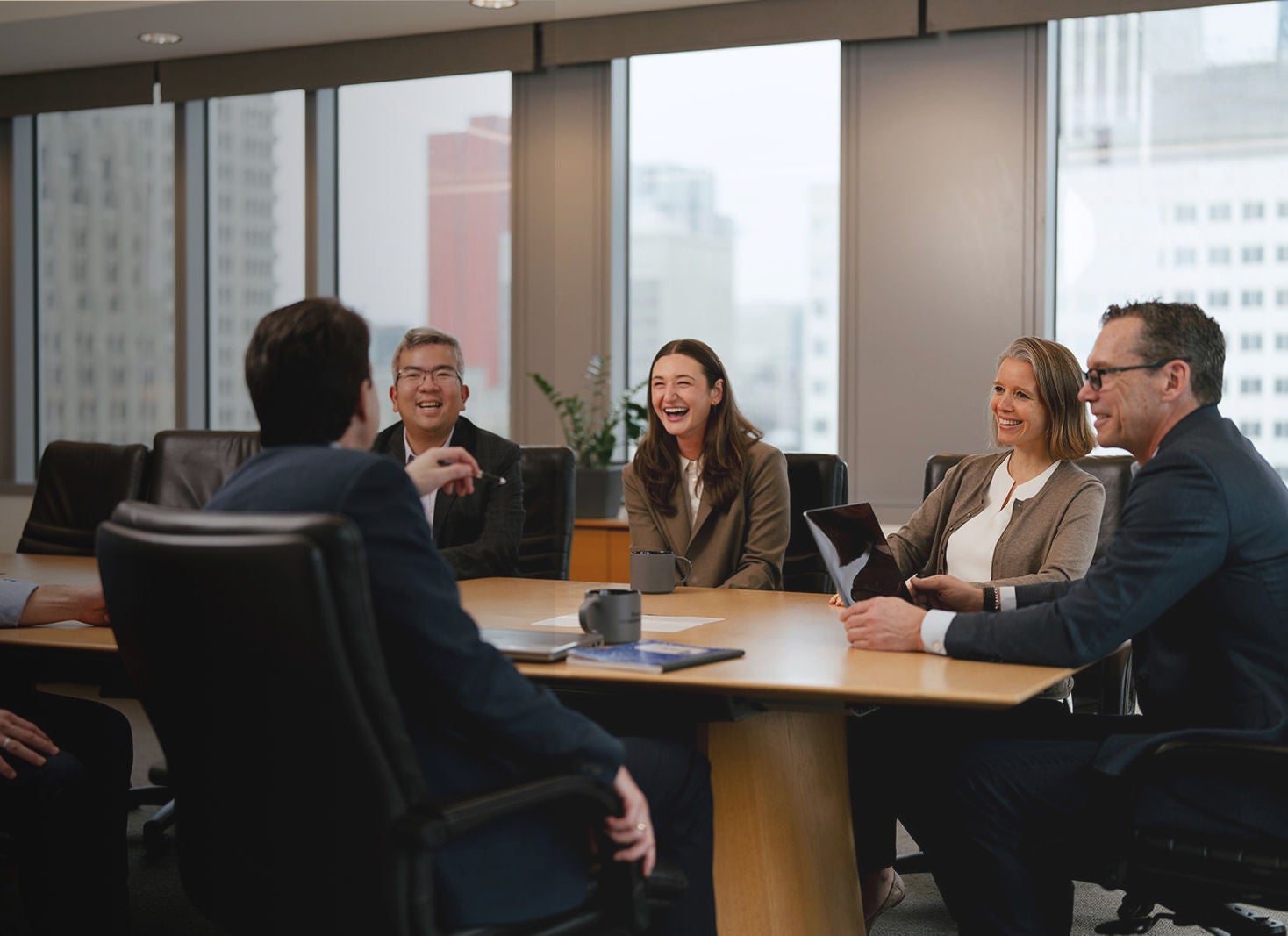 5 people conversing in an office space