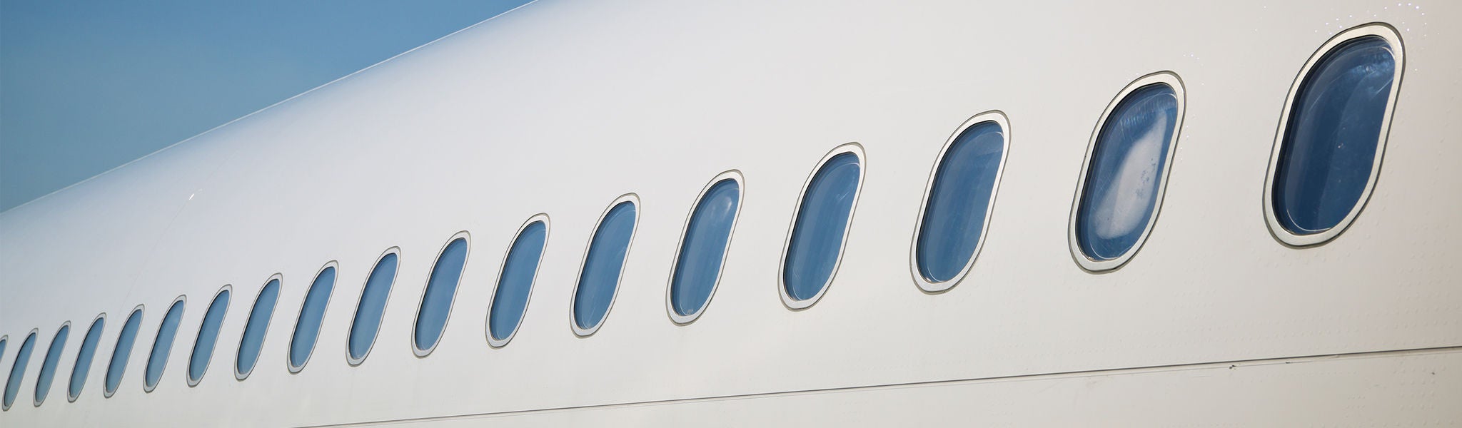 Row of airplane windows on fuselage