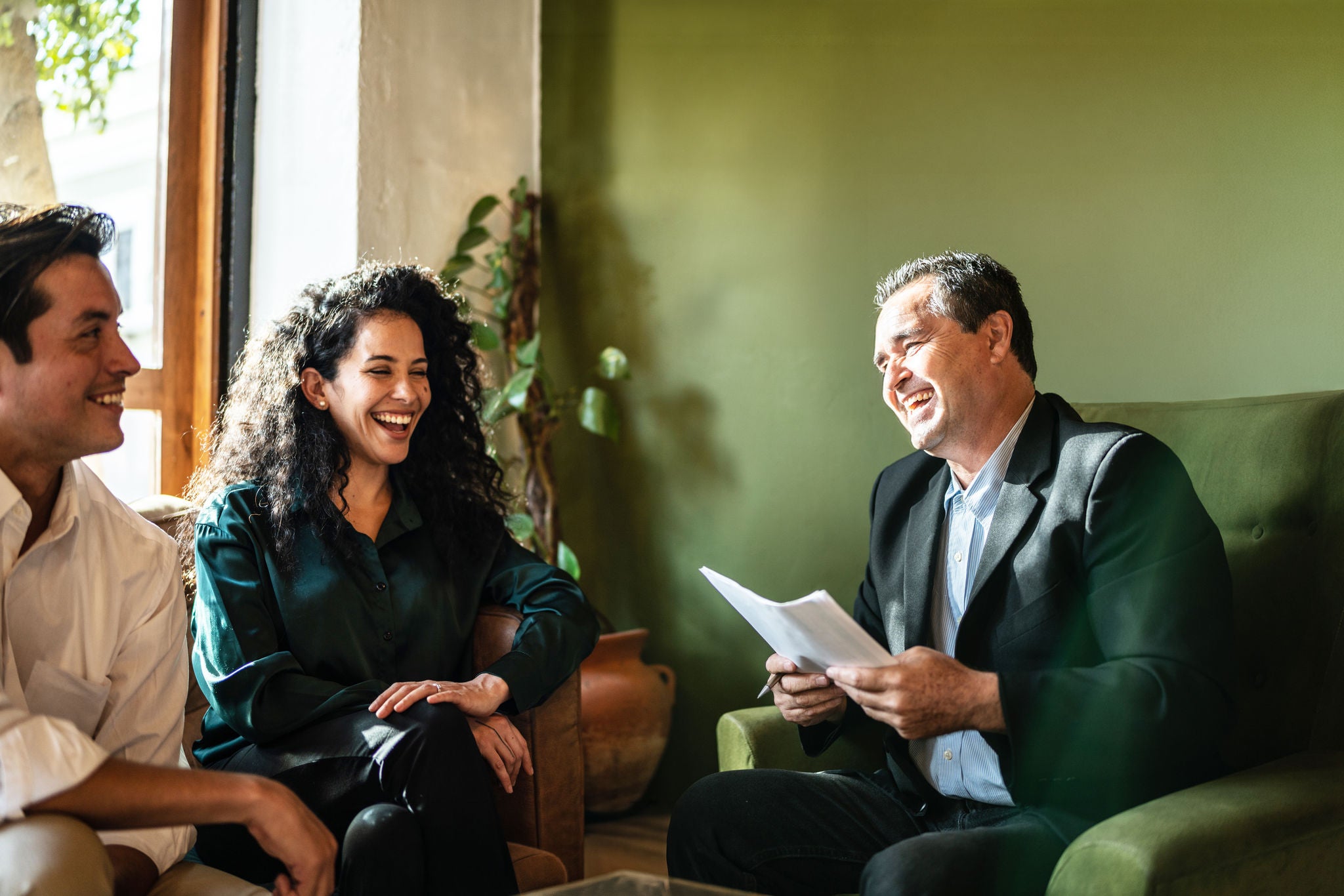 Mid adult couple having a meeting with a financial advisor at a coffee shop
