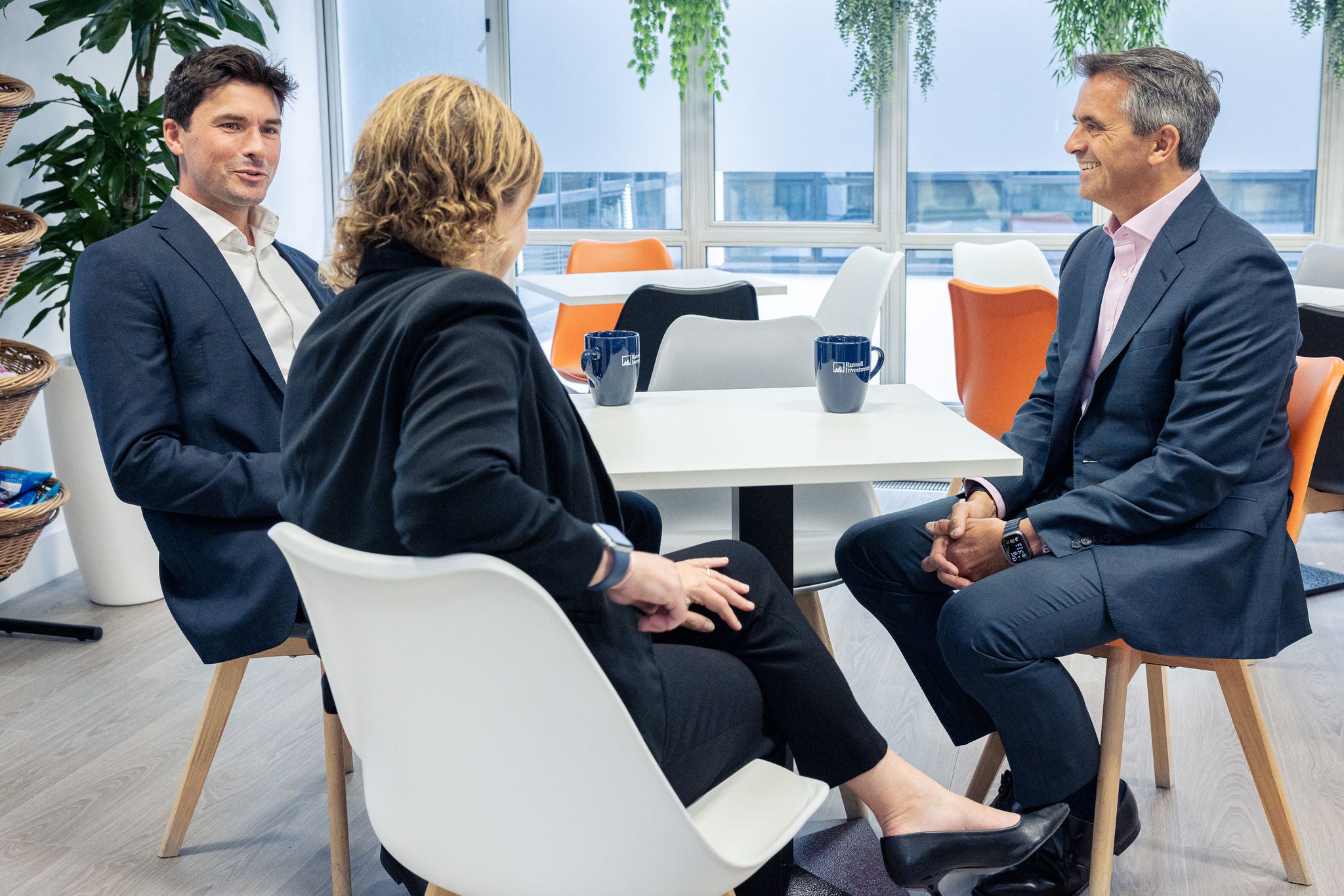 Group of people sitting in office & discussing.
