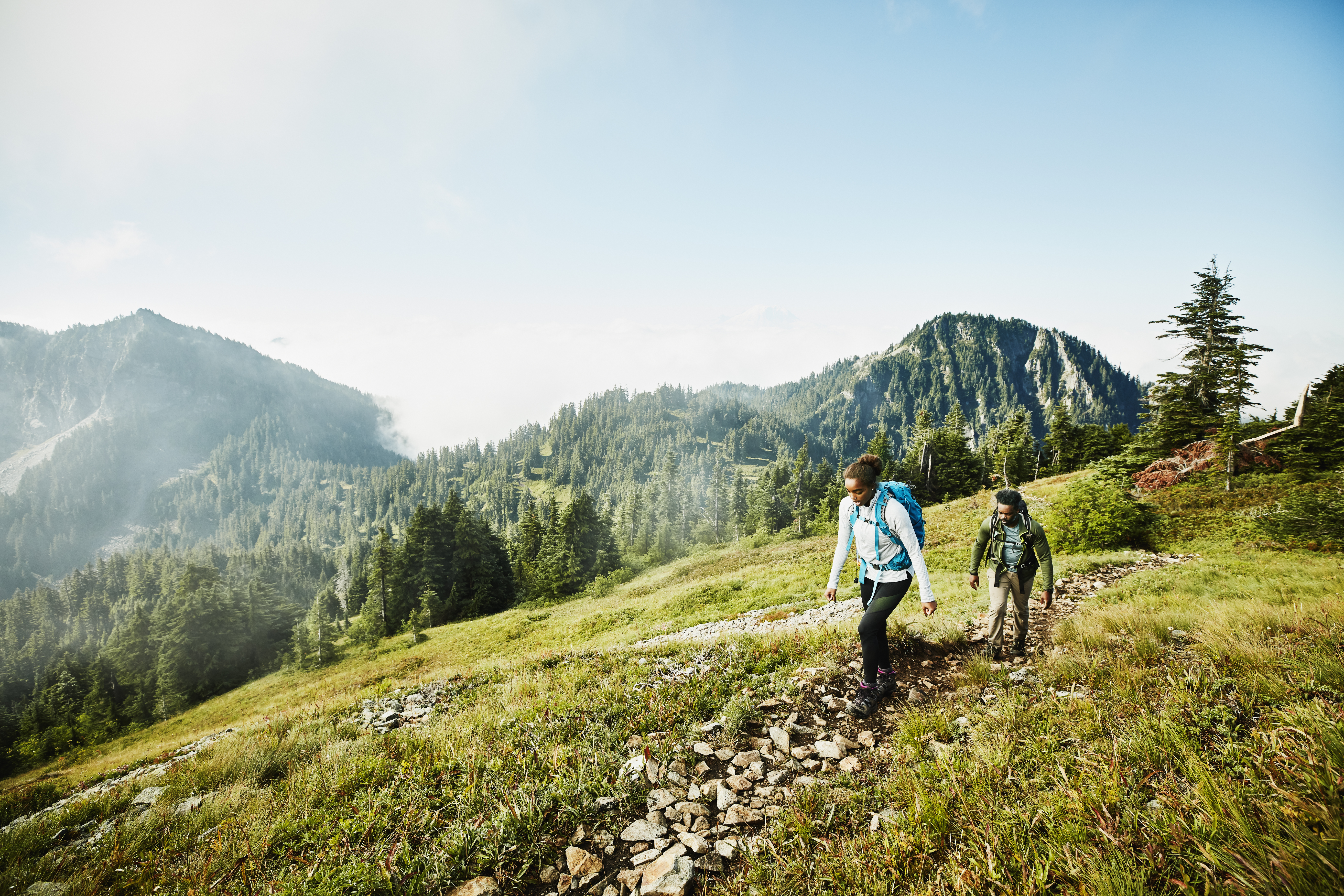 two people climbing a mountain