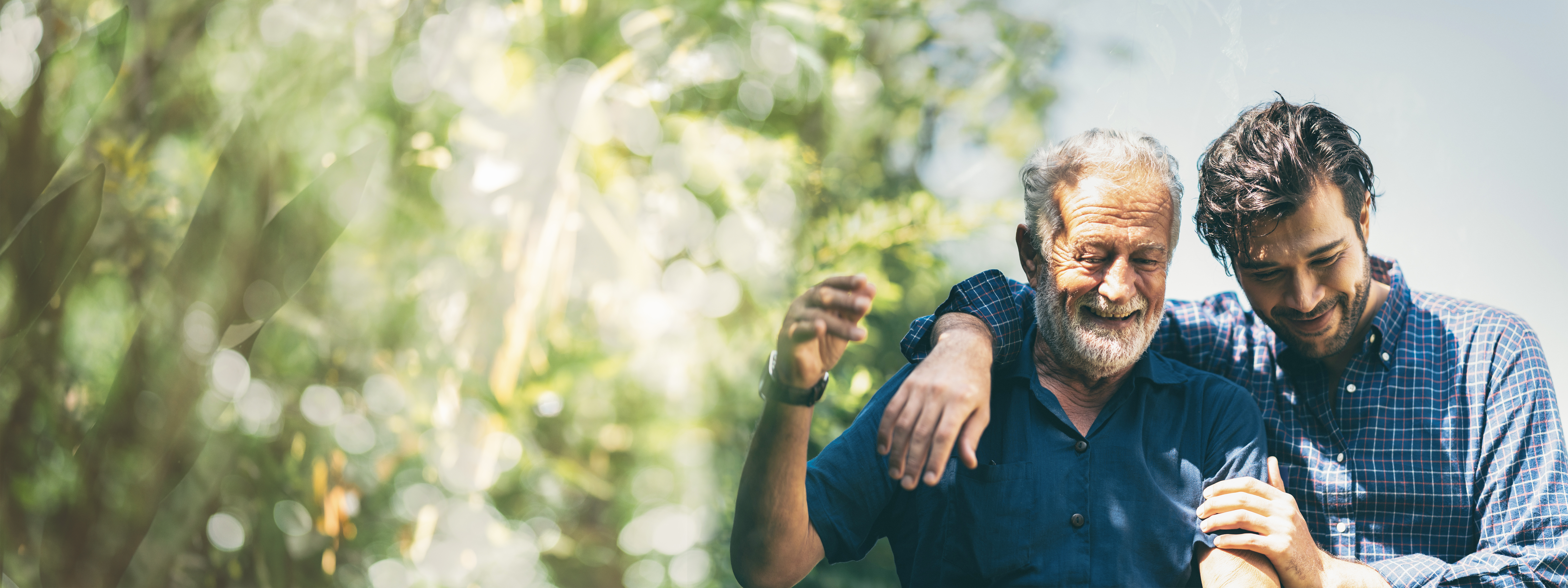A man side hugging an old man