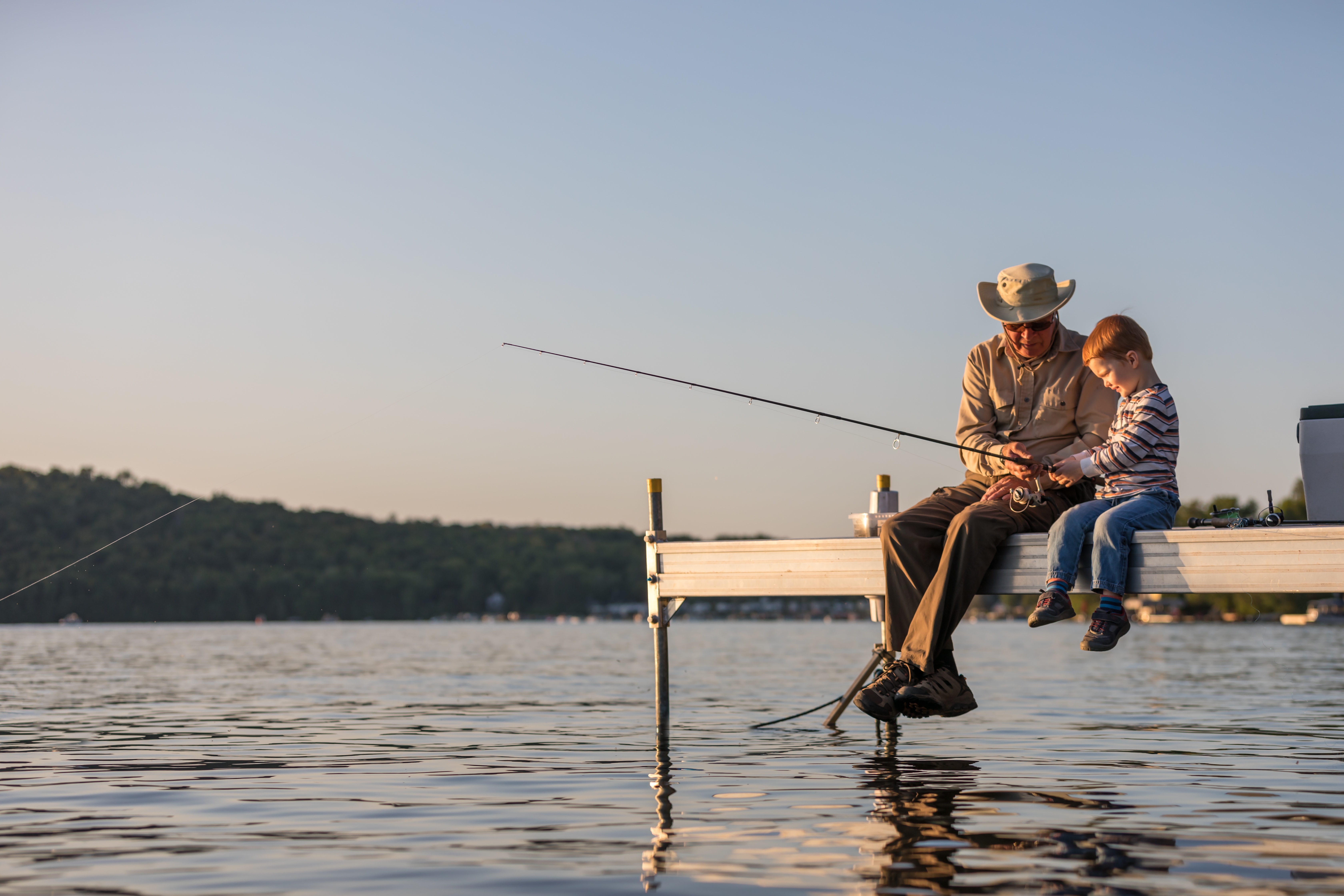 Grandpa teaching his grandson fishing