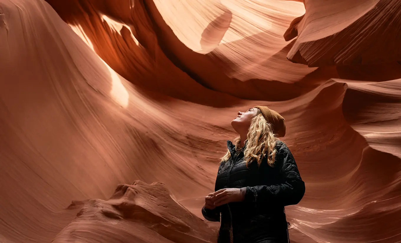 woman looking up out of cave