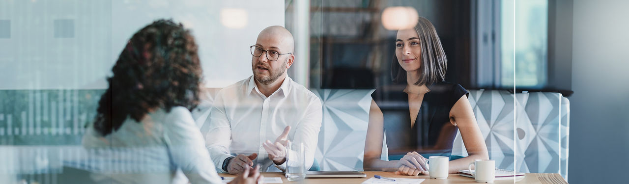 Two women and man sitting at table