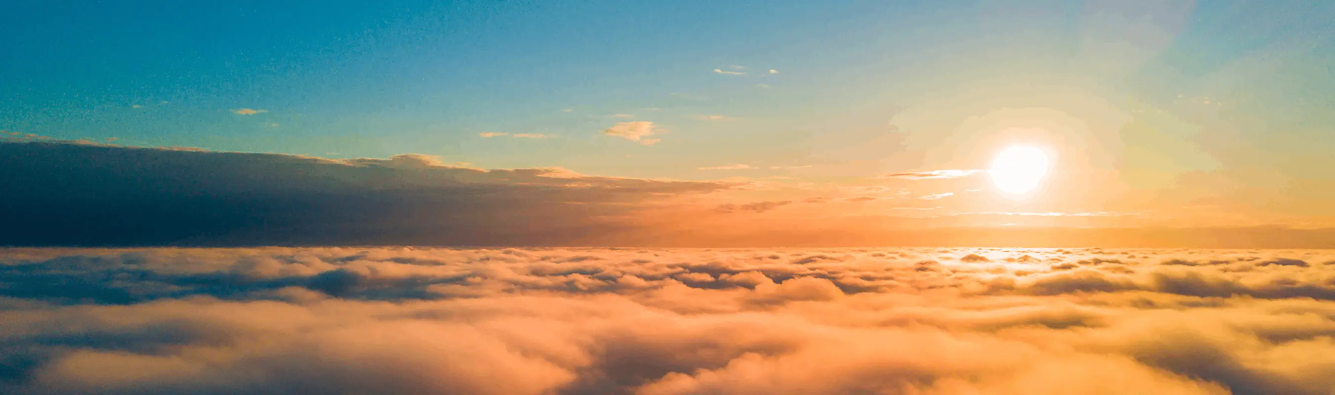 Sunrise above clouds with vibrant sky colors