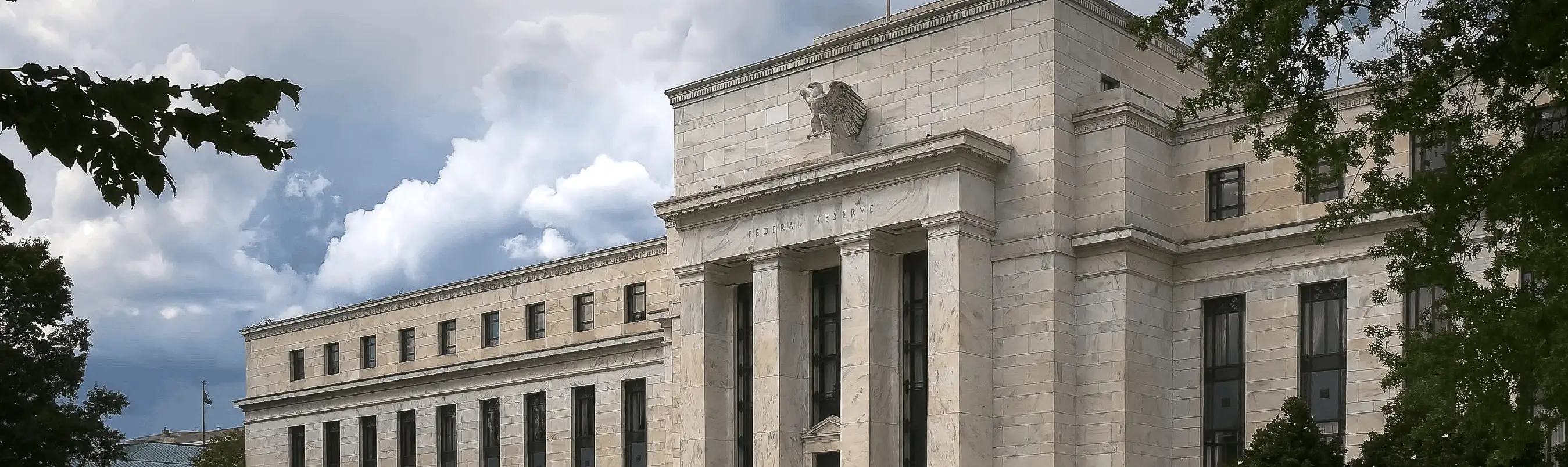 Historic stone government building under cloudy sky