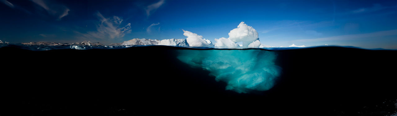 Greenland, Ilulissat, Underwater image of icebergs floating near face of Jakobshavn Isfjord on summer afternoon