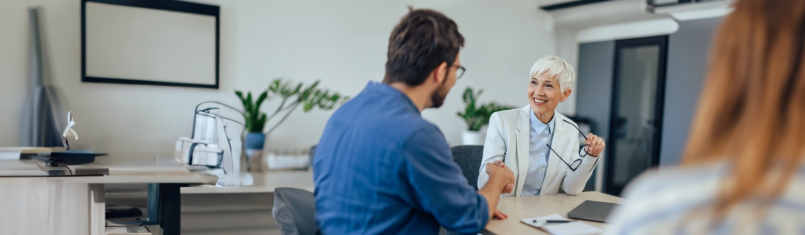 Mature businesswoman shaking hands with a client