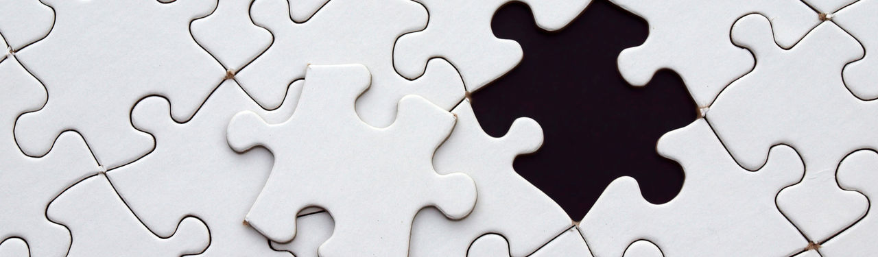 Conceptual photography with black and yellow paper airplanes on a smudged blackboard.