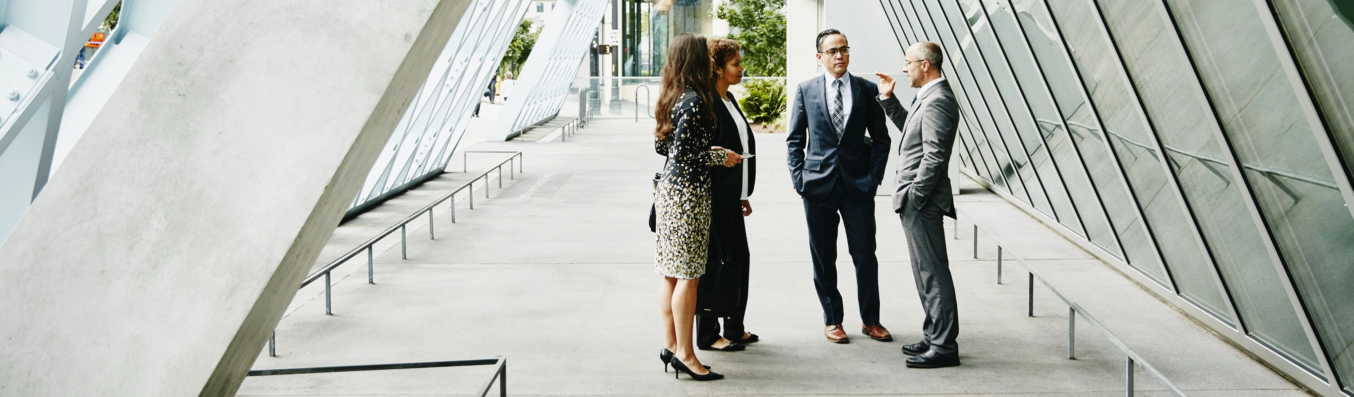Business professionals talking in modern atrium
