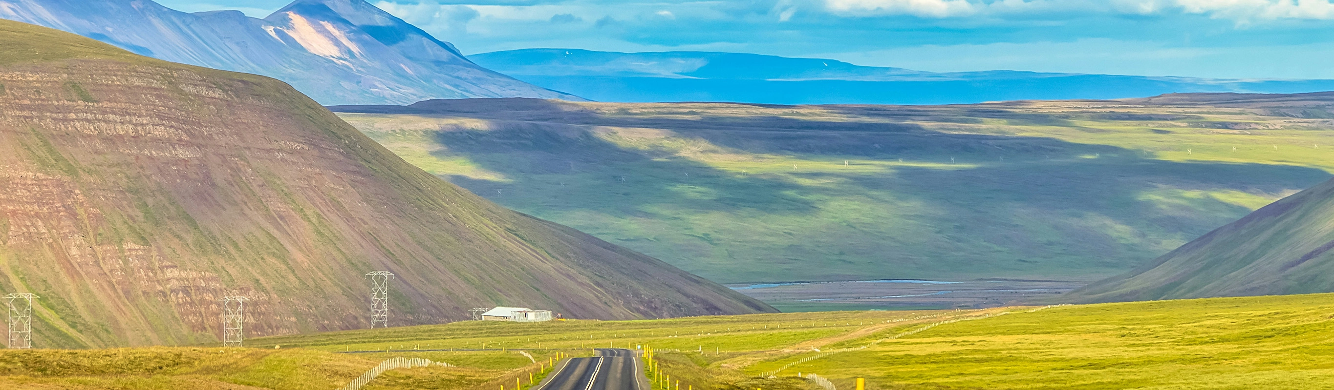 Scenic Road Through Lush Green Mountain Valley