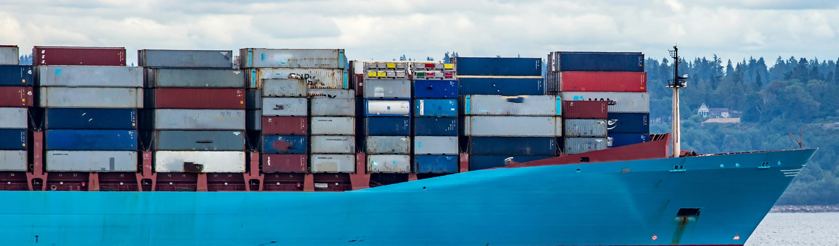 Cargo ship with stacked shipping containers at port