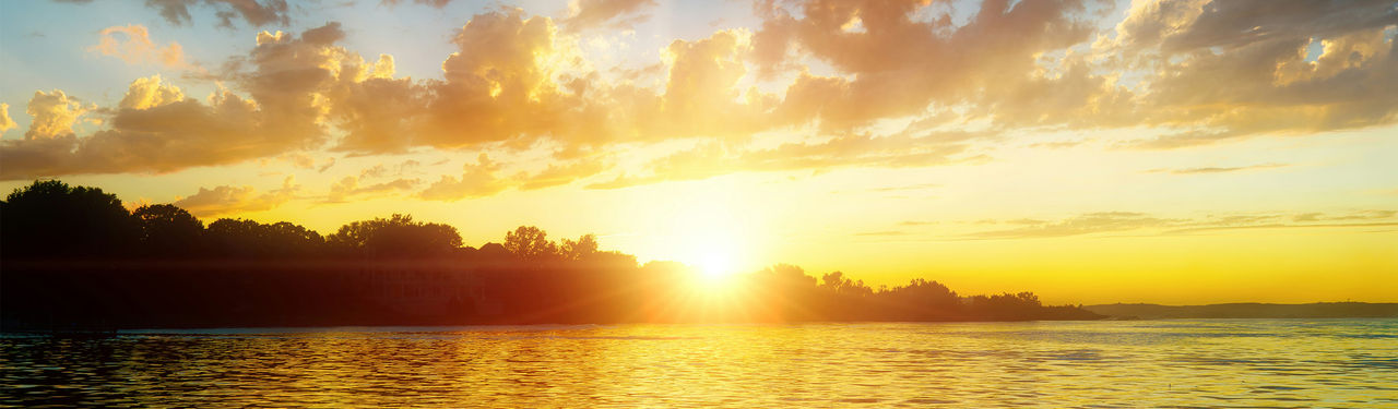Golden sunset over tranquil lake