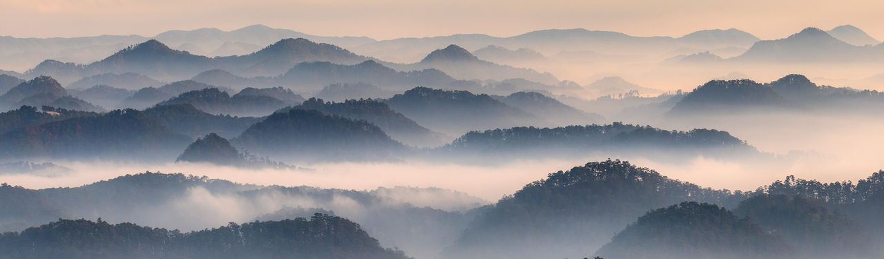 Misty mountain range at sunrise