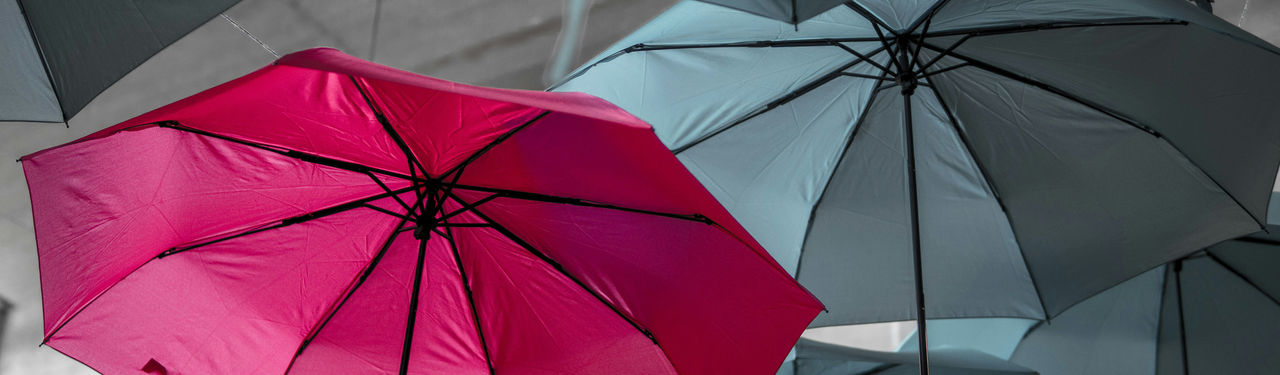 Bright red umbrella among muted tones