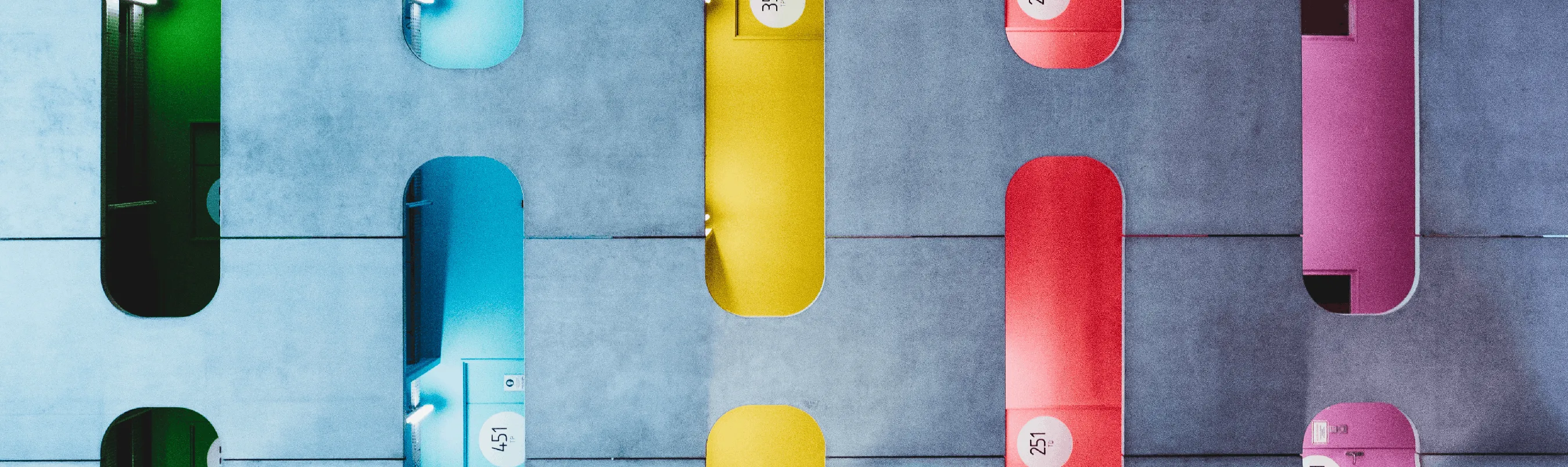 Colorful lockers with numbered doors in modern hallway