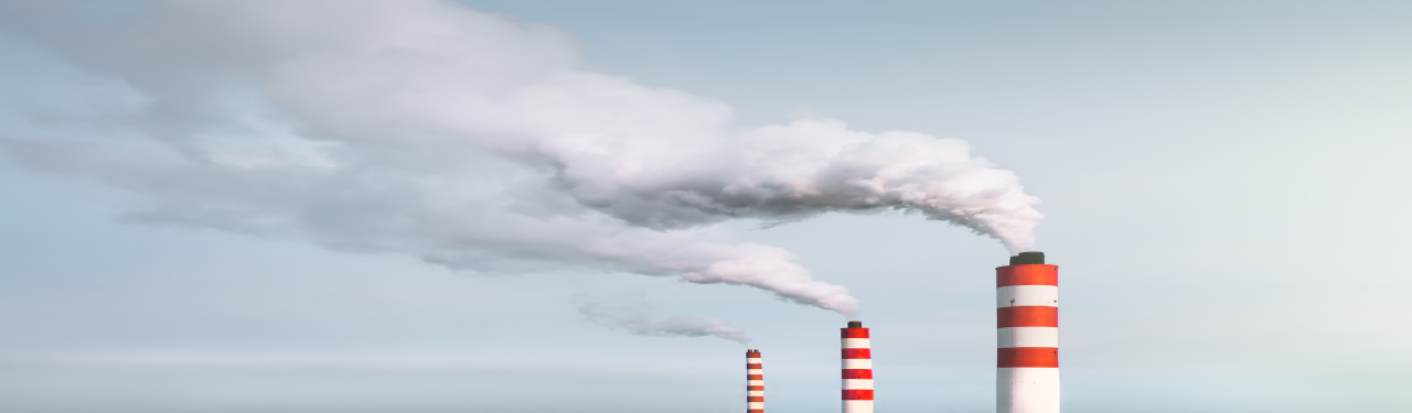 Industrial Smokestacks Emitting Thick White Smoke