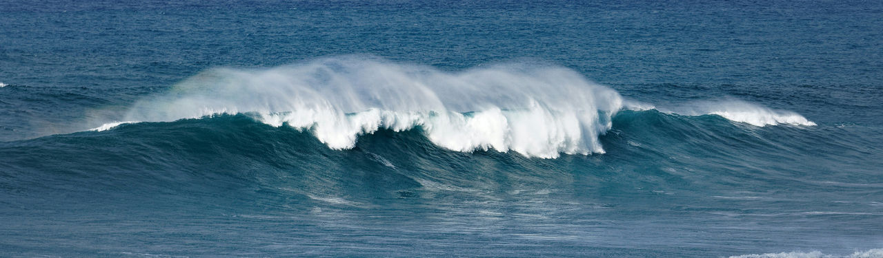 Ocean waves crashing in blue waters